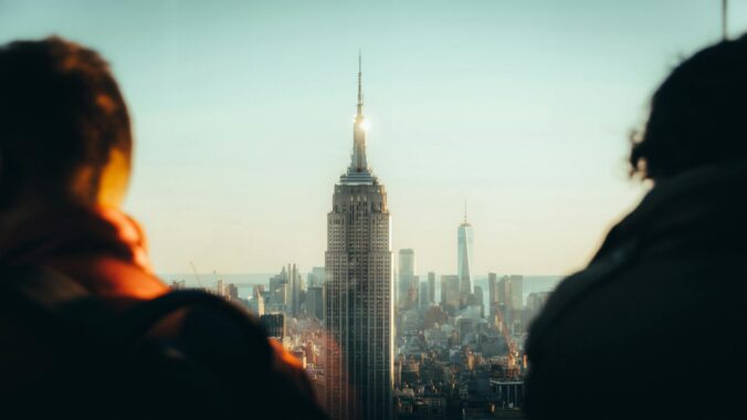 people looking at empire state building new york