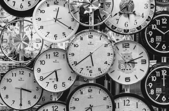 black and white photo of clocks
