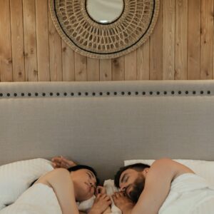 romantic couple lying on bed while sleeping